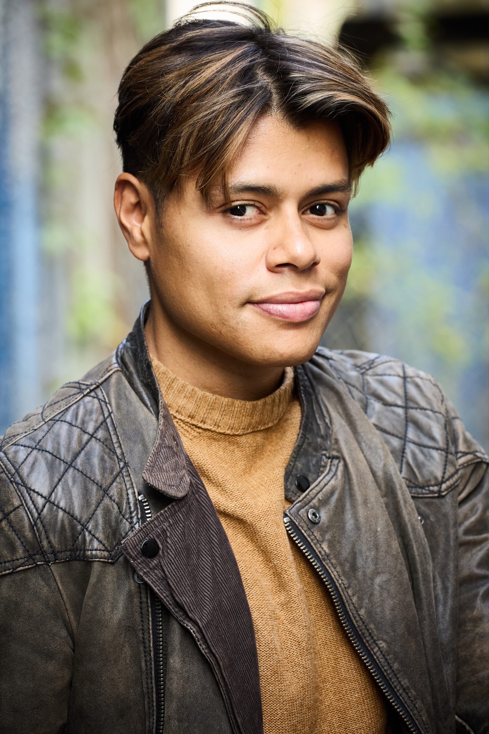 Aaron Stier in a warm natural-light portrait wearing a leather jacket