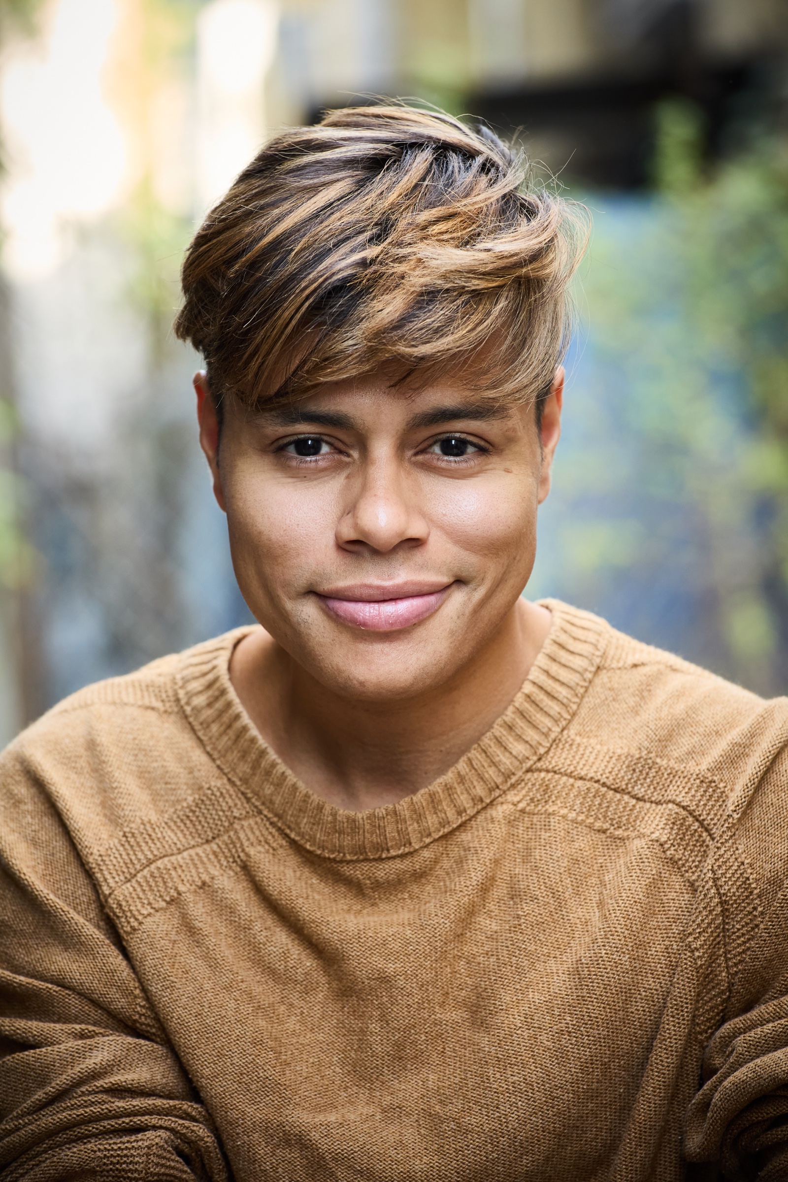 Aaron Stier smiling in a warm-toned headshot